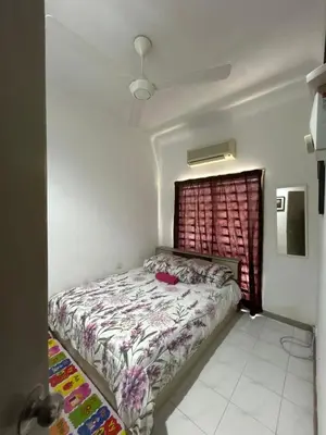 a bedroom with a bed in a room with a window at GerchangLakeHouse in Behrang Hulu