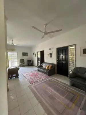 a living room with a couch and a ceiling fan at GerchangLakeHouse in Behrang Hulu