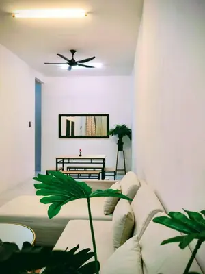 a living room with a couch and a ceiling fan at Myrol Homestay Padang Serai Kulim in Padang Serai