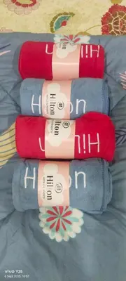 a group of four towels on a bed at Kampung Homestay in Sungai Petani