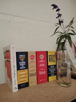 a shelf with books and a vase with a flower in a bottle at Fantasy Stay Cameron Highlands in Kampung Kuala Terla