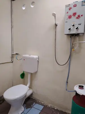 a bathroom with a toilet and a sink at Fantasy Stay Cameron Highlands in Kampung Kuala Terla