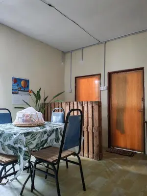 a room with a table and chairs and a fence at Fantasy Stay Cameron Highlands in Kampung Kuala Terla