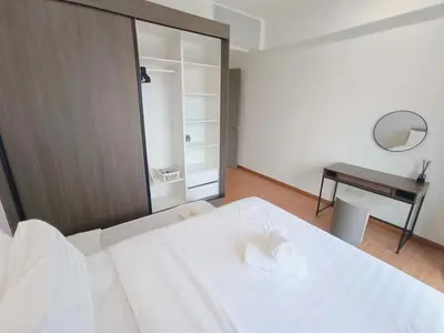 a bedroom with a large white bed and a desk at Rooftop Pool, Up to 6 Pax, 2 Bedrooms, 2 Bathrooms, 2 Car Parks by Star Home in George Town