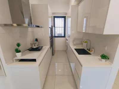 a white kitchen with white counters and a sink at Rooftop Pool, Up to 6 Pax, 2 Bedrooms, 2 Bathrooms, 2 Car Parks by Star Home in George Town