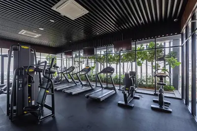 a gym with a row of treadmills and ellipticals at Rooftop Pool, Up to 6 Pax, 2 Bedrooms, 2 Bathrooms, 2 Car Parks by Star Home in George Town