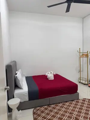 a bedroom with a bed with a red blanket at Ramadhina The Luxe Retreat Home2stay Ipoh in Ipoh
