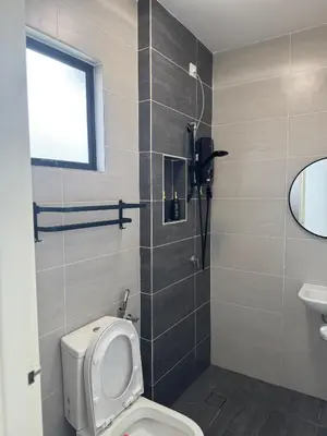 a bathroom with a toilet and a sink at Ramadhina The Luxe Retreat Home2stay Ipoh in Ipoh