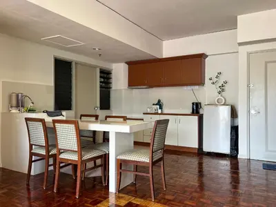 a kitchen with a table and chairs and a refrigerator at Moriash Stay in Brinchang