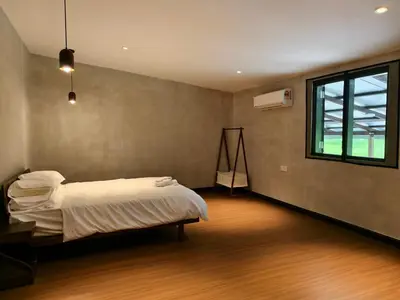 a bedroom with a bed and a window at Rumah Atuk Homestay in Gua Musang