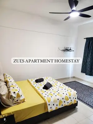 a bed in a room with a sign on the wall at Zuls Apartment Homestay Cameron Highlands in Tanah Rata