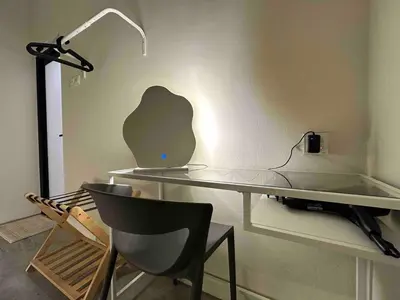 a glass desk with a lamp and a chair at Moonine Homes Taiping in Kamunting