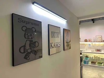 a hallway with three framed pictures on a wall at Moonine Homes Taiping in Kamunting