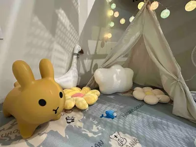 a childs bedroom with a bed with toys and a tent at Moonine Homes Taiping in Kamunting