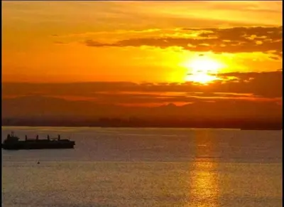 a boat on the water with the sunset in the background at Georgetown 2R1B Gleneagle Gurney City Sea view in George Town