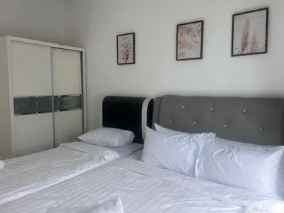 a bedroom with two beds with white sheets and a mirror at Georgetown 2R1B Gleneagle Gurney City Sea view in George Town