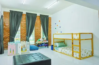 a bedroom with a bunk bed and a couch at DAWA Brickhouse - Balinese Guesthouse in Thompson Ipoh by Ryokan Management in Ipoh