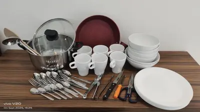 a table with a bunch of dishes and utensils at City Sea View 2R2B Georgetown Gleneagle 9pax in George Town