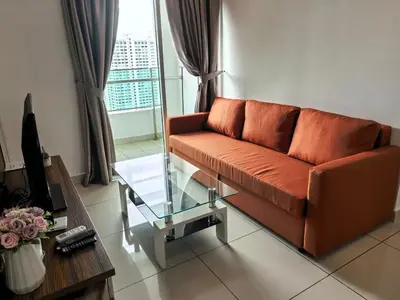 a living room with a couch and a glass table at City Sea View 2R2B Georgetown Gleneagle 9pax in George Town