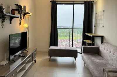 a living room with a couch and a television at Simple Stay Aston Acacia Bukit Mertajam in Bukit Mertajam