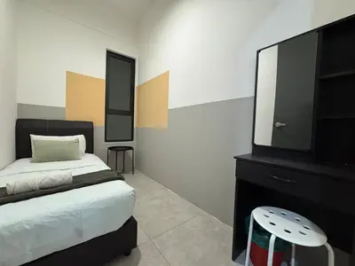 a bedroom with a bed and a dresser with a mirror at Simple Stay Aston Acacia Bukit Mertajam in Bukit Mertajam
