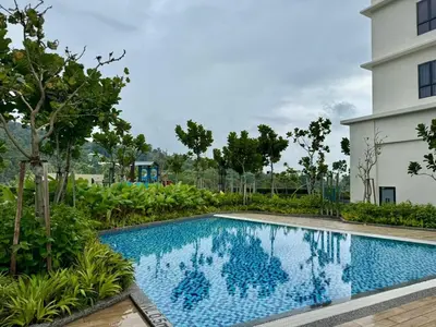 a swimming pool in front of a building at Simple Stay Aston Acacia Bukit Mertajam in Bukit Mertajam