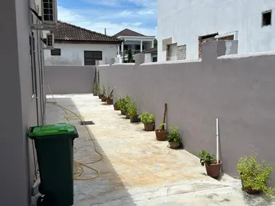 a fence with a row of potted plants on it at Cozy 4BR Homestay with 2 Baths Taman Seraya in Kulim