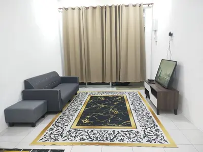 a living room with a couch and a tv at Hannan Homestay in Kuala Lipis