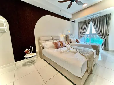 a bedroom with a bed and a ceiling fan at ICC Luxury Suites by Grab A Stay in Ipoh