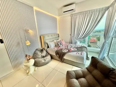 a bedroom with a bed and a large window at ICC Luxury Suites by Grab A Stay in Ipoh
