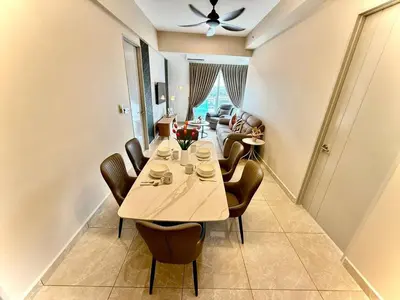 a dining room with a table and chairs at ICC Luxury Suites by Grab A Stay in Ipoh