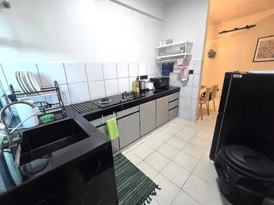 a small kitchen with a sink and a stove at The Highland Hive in Tanah Rata
