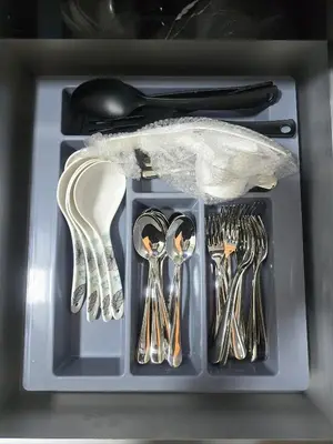 a plastic container with utensils in a drawer at The Highland Hive in Tanah Rata