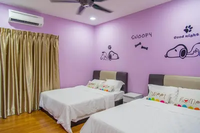 two beds in a room with purple walls at Lavender Home in Sekincan