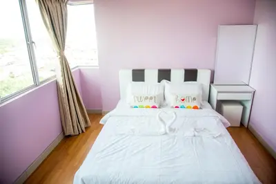 a bedroom with a white bed and a window at Lavender Home in Sekincan