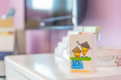 a card with a picture of two people on a table at Lavender Home in Sekincan