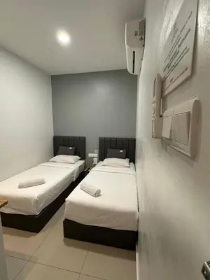 a room with two beds in a room at LM Motel in Kulim