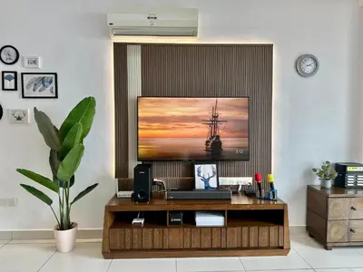 a living room with a tv on a wall at New Reno Jazz Suite 2 bedroomsSeaviewKaraoke in Tanjong Tokong