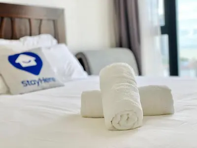 a rolled up towel on top of a bed at New Reno Jazz Suite 2 bedroomsSeaviewKaraoke in Tanjong Tokong