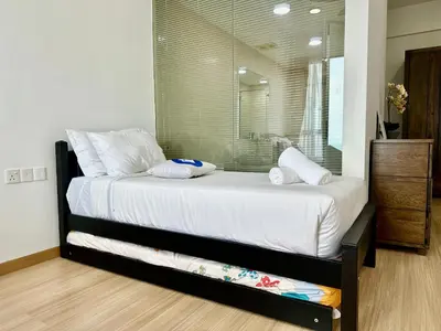 a bedroom with a large bed with a mirror at New Reno Jazz Suite 2 bedroomsSeaviewKaraoke in Tanjong Tokong