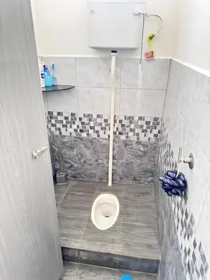 a small bathroom with a toilet in a stall at Homestay Tanah Liat in Bukit Mertajam