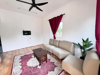 a living room with a couch and a table at Homestay Tanah Liat in Bukit Mertajam