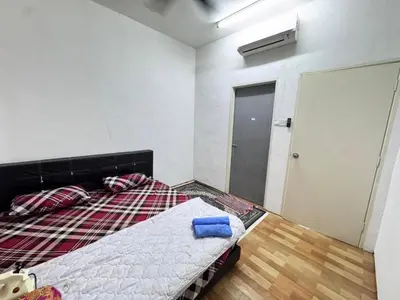 a bedroom with a bed in a room with a door at Homestay Tanah Liat in Bukit Mertajam