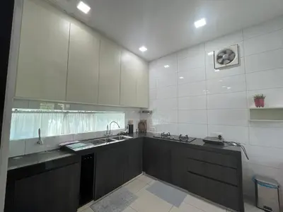a large kitchen with white cabinets and a sink at Asimmy Homestay Semi-D with 4 rooms in Kampong Gurun