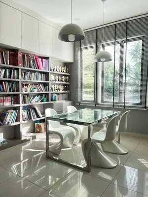 a dining room with a glass table and white chairs at Asimmy Homestay Semi-D with 4 rooms in Kampong Gurun