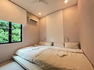 a large bed in a room with a window at Asimmy Homestay Semi-D with 4 rooms in Kampong Gurun