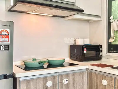 a kitchen with two bowls on a counter with a microwave at Majestic Condo Ipoh Central by PLY Home in Ipoh