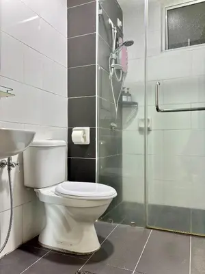 a bathroom with a toilet and a glass shower at Majestic Condo Ipoh Central by PLY Home in Ipoh