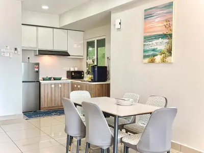 a kitchen and dining room with a table and chairs at Majestic Condo Ipoh Central by PLY Home in Ipoh