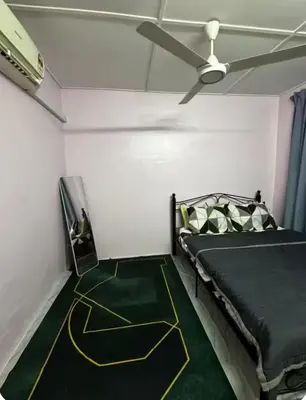 a bedroom with a bed and a ceiling fan at Aileen Homestay Swimming Pool in Batu Gajah
